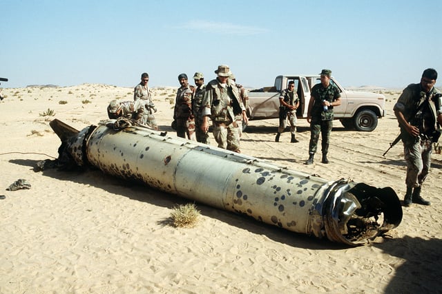 Military personnel examine the remains of a Scud.
