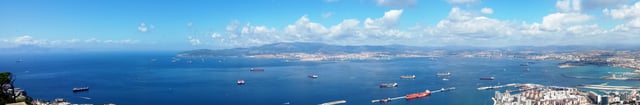 Morocco (top far left across Strait); Spain: Algeciras (top centre across Bay of Gibraltar) and La Linea (right); Gibraltar cruise port and airport runway (right foreground); from the Rock