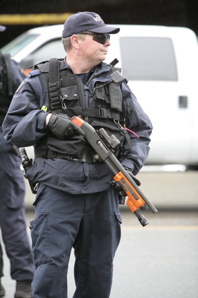 A RCMP officer in 2010 armed with a shotgun outfitted to fire beanbag rounds