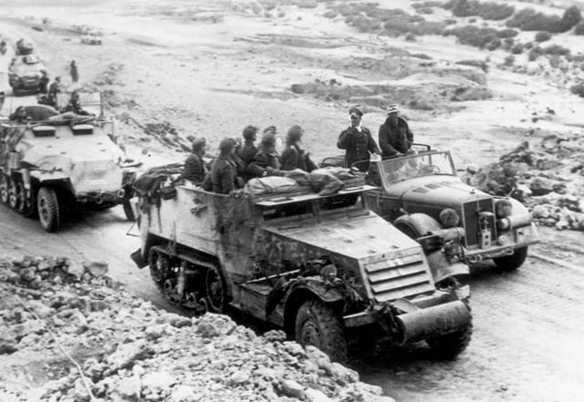 Rommel speaks with troops who are using a captured American M3 half-track, Tunisia.