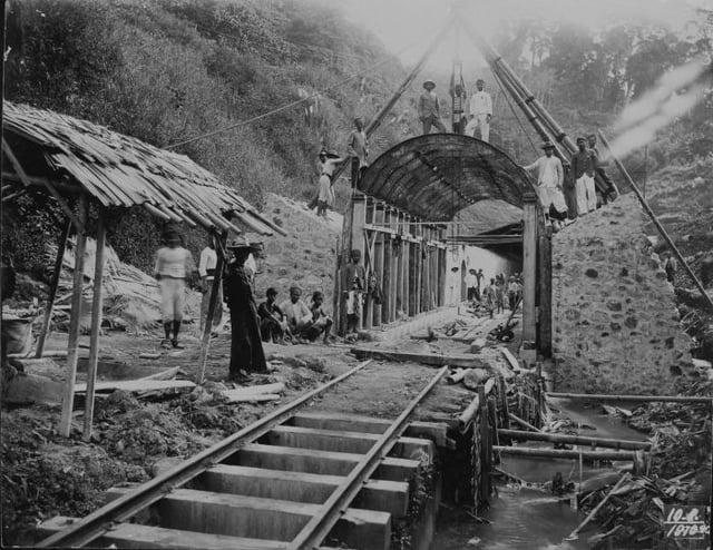 Workers pose at the site of a railway tunnel under construction in the mountains, 1910.