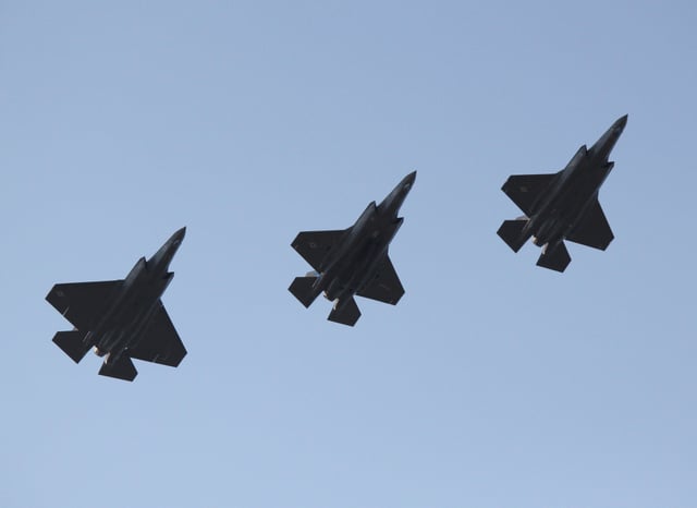 Two F-35 variants in formation. From left: The F-35C (left) has a larger wing than two F-35Bs.