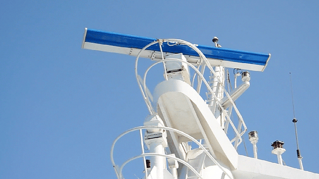 Rotating marine radar antenna on ship.