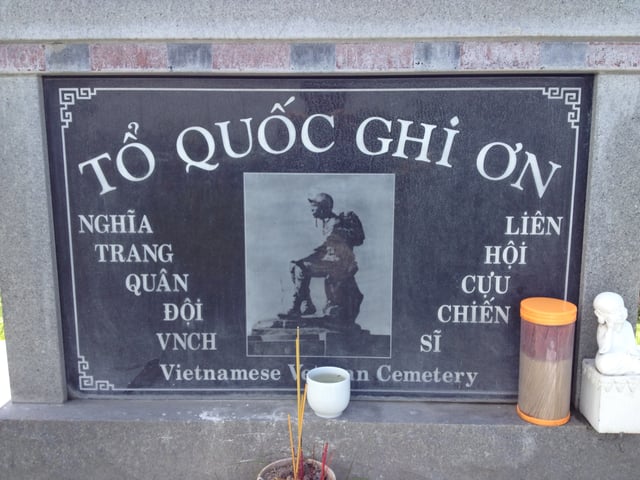 Stone plaque with photo of the "Thương tiếc" (Mourning Soldier) statue, originally, installed at the Republic of Vietnam National Military Cemetery. The original statue was demolished in April 1975.
