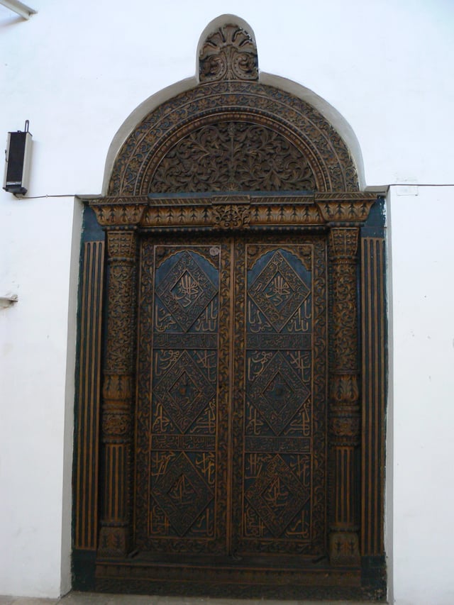 A carved door with Arabic calligraphy in Zanzibar