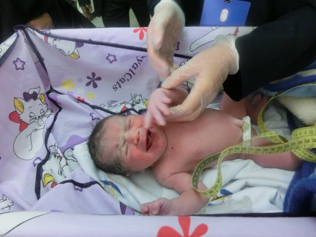 A 30-minute-old infant receiving routine care.