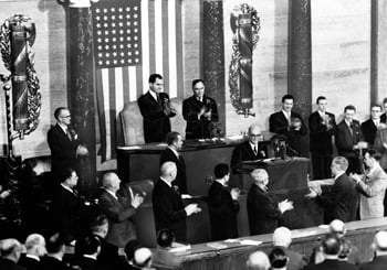 President Celal Bayar of Turkey receives a standing ovation after his speech before a joint session of Congress. Behind him are Vice-President Nixon and Speaker of the House Sam Rayburn (1954).