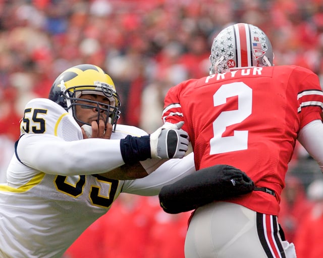 Terrelle Pryor (right) eludes Brandon Graham with a stiff arm.