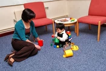 A child exploring comfortably due to having a secure attachment with caregiver.