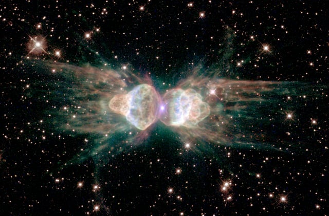 Mz 3, often referred to as the Ant planetary nebula. Ejecting gas from the dying central star shows symmetrical patterns unlike the chaotic patterns of ordinary explosions.
