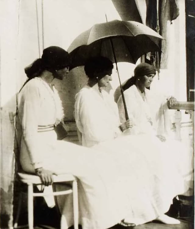 The last photograph ever taken of Alexandra. With her are her daughters Olga (right) and Tatiana (left). They are sitting on the balcony of the Governor's Mansion, Tobolsk, in Siberia in spring of 1918.