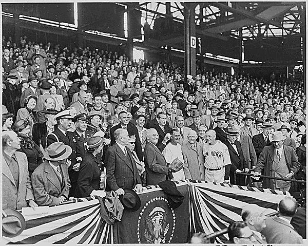 Opening Day of the 1951 baseball season at Griffith Stadium. President Harry Truman throws out the first ball as Bucky Harris and Casey Stengel look on.