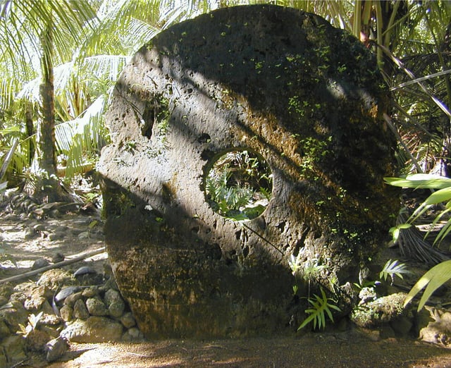 A large (approximately 8 feet in height) example of Yapese stone money (Rai) in the village of Gachpar