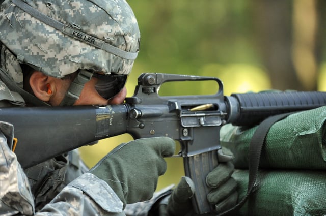 U.S. soldier fires M16A2. Note: upper receiver showing carrying handle and rear sight