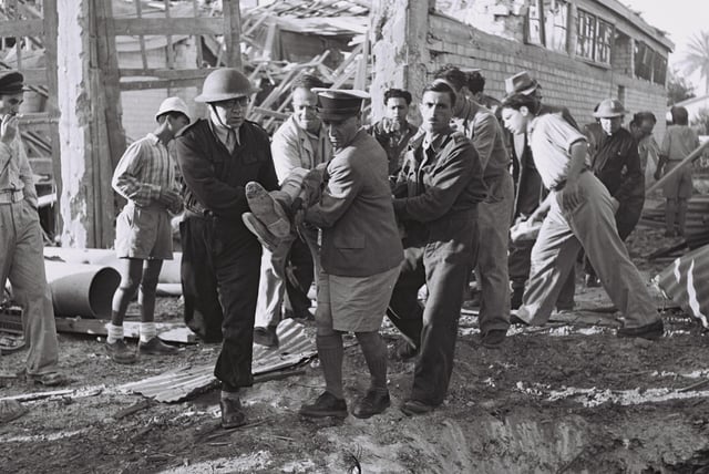 Volunteers evacuating a wounded man during Egyptian bombardment of Tel Aviv.