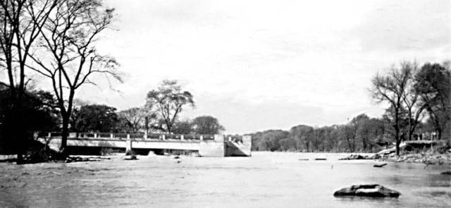 The Lawrence Avenue bridge over the Humber River was washed out by Hurricane Hazel; part of it remained attached to the shore, while the rest was swept away by the river.