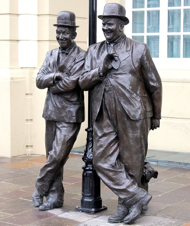 Statue of Stan Laurel and Oliver Hardy outside the Coronation Hall Theatre, Ulverston, Cumbria, England