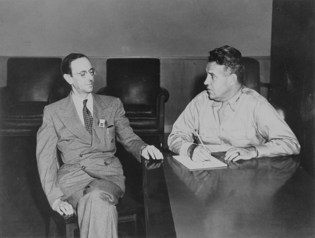 Groves confers with James Chadwick, the head of the British Mission.