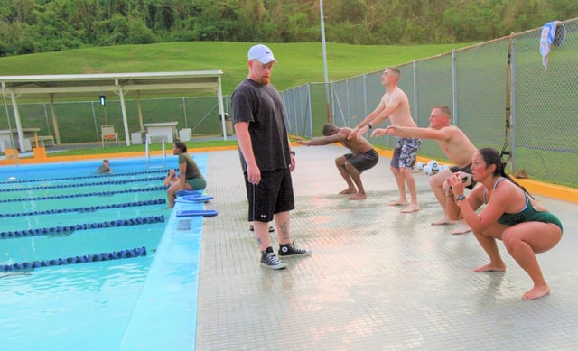 Swimmers perform squats prior to entering the pool in a U.S. military base, 2011.