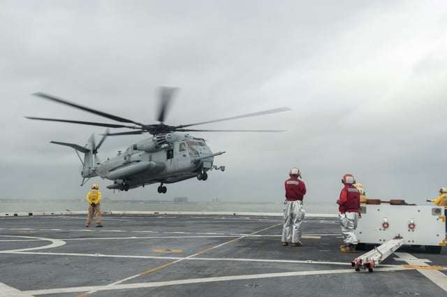 A CH-53E Sea Stallion helicopter assigned to the 24th Marine Expeditionary Unit, lands on the flight deck of the amphibious transport dock ship USS Mesa Verde. It is underway in preparation to support humanitarian assistance and disaster relief efforts in Haiti in response to Hurricane Matthew