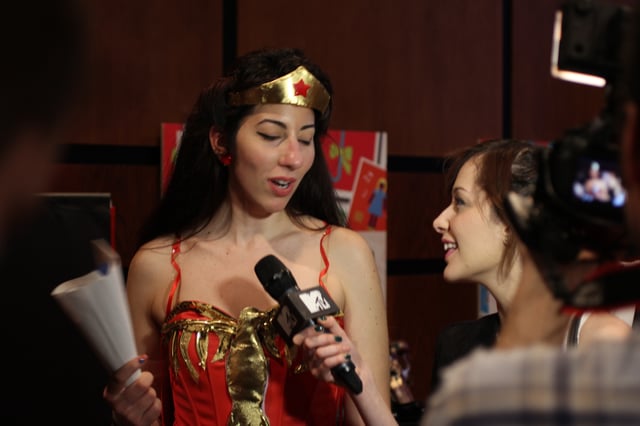Journalists interviewing a cosplayer