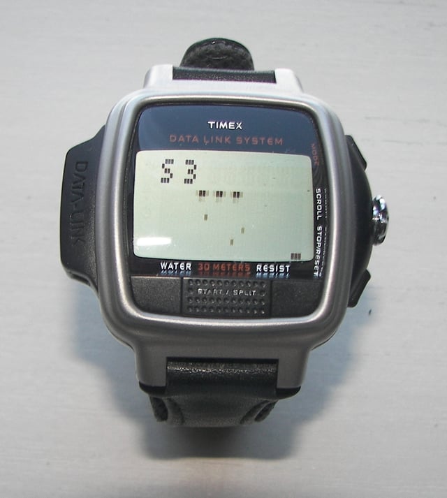 Timex Datalink USB Dress edition from 2003 with a dot matrix display; the Invasion video game is on the screen