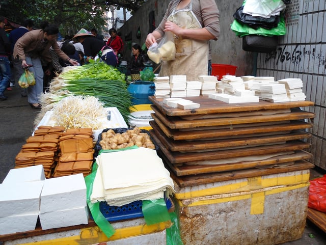 Several kinds of soybean products are sold in a farmer's market in Haikou, China.