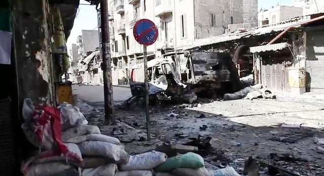 Destroyed vehicle on a devastated Aleppo street, 6 October 2012
