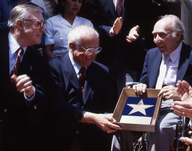 Johnny Grant, center, at producer Joe Pasternak's presentation ceremony in 1991. At left is Gene Kelly.