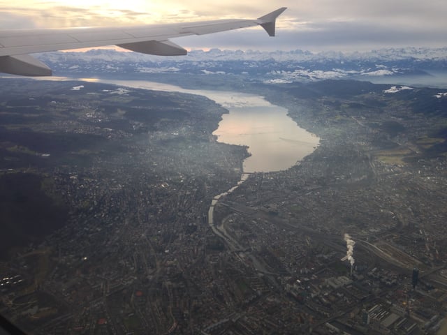 The city stretches on both sides of the Limmat, which flows out of Lake Zürich. The Alps can be seen from the city center, background to the lake.