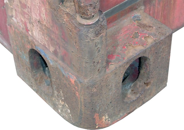 The standard castings on the eight corners of each container. The twistlock proper is done through a larger oval hole on the top or bottom.