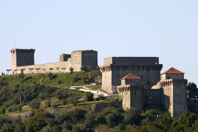 Castle of Ourém. The two towers flanking the entrance are located in the front right, with the ruins of the large palace of Count Afonso just behind them. The oldest portions of the castle are located in the back left of the image.