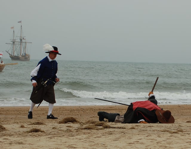 Man kissing the ground after a long sea voyage (as part of a reenactment of the first landing of English settlers in Virginia in 1607)