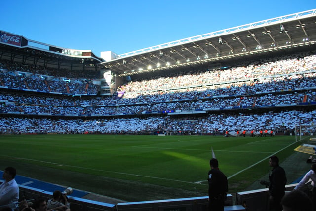 Real Madrid fans displaying the white of their club before El Clásico. Real Madrid fans also often wave Spanish flags at El Clásico games.