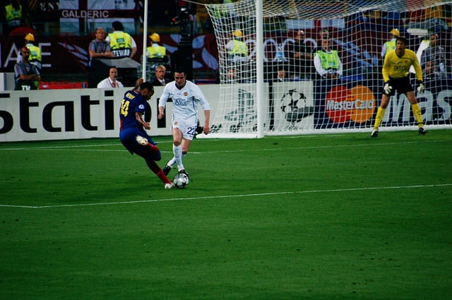 Henry taking on Manchester United defender John O'Shea. In his prime, Henry would often drift out to the left wing position and run towards goal.