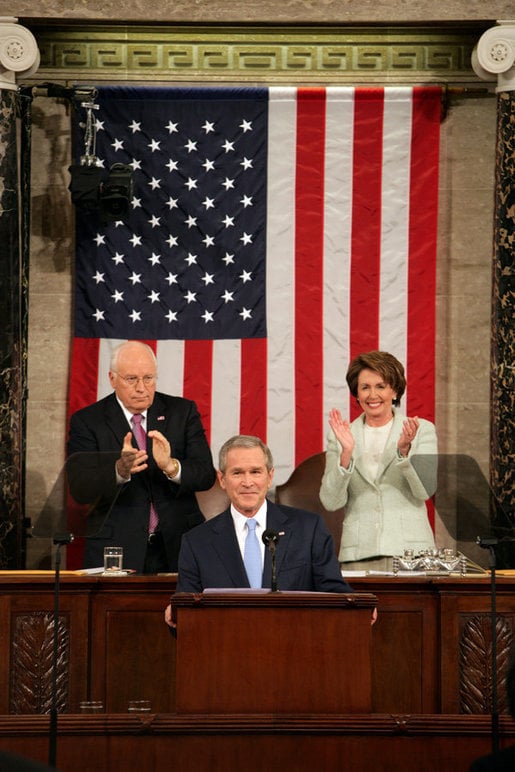 Speaker Nancy Pelosi (right) with Vice President Dick Cheney behind President George W. Bush at the 2007 State of the Union Address making history as the first woman to sit behind the podium at such an address. President Bush acknowledged this by beginning his speech with the words, "Tonight, I have a high privilege and distinct honor of my own — as the first president to begin the State of the Union message with these words: Madam Speaker".