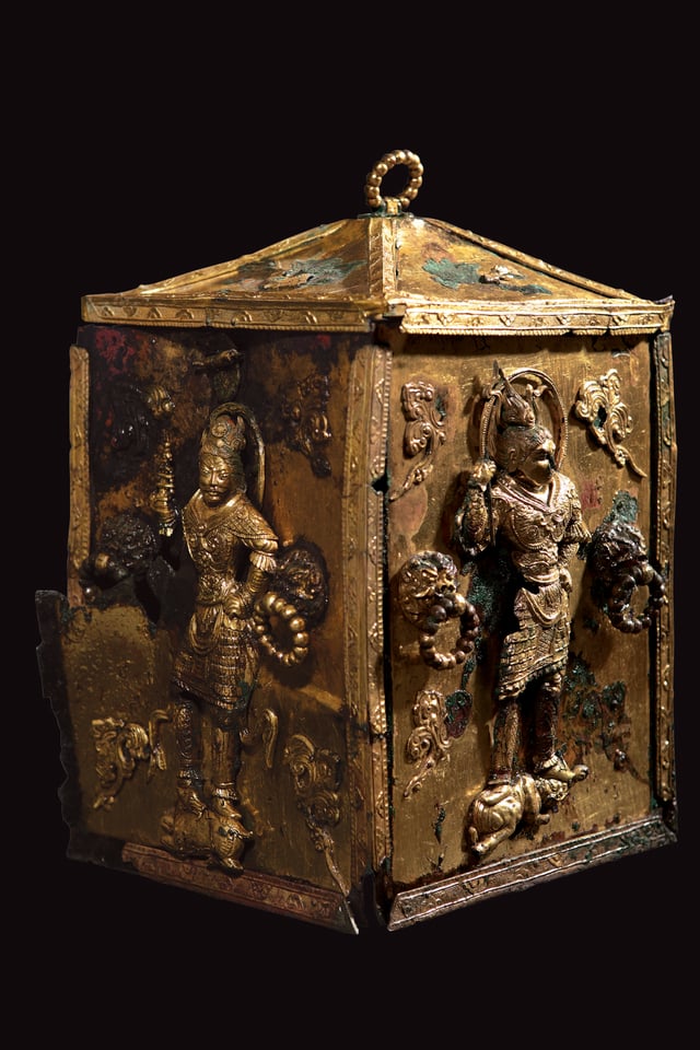 A gilt Buddhist reliquary with decorations of armored guards, from Silla, 7th-century