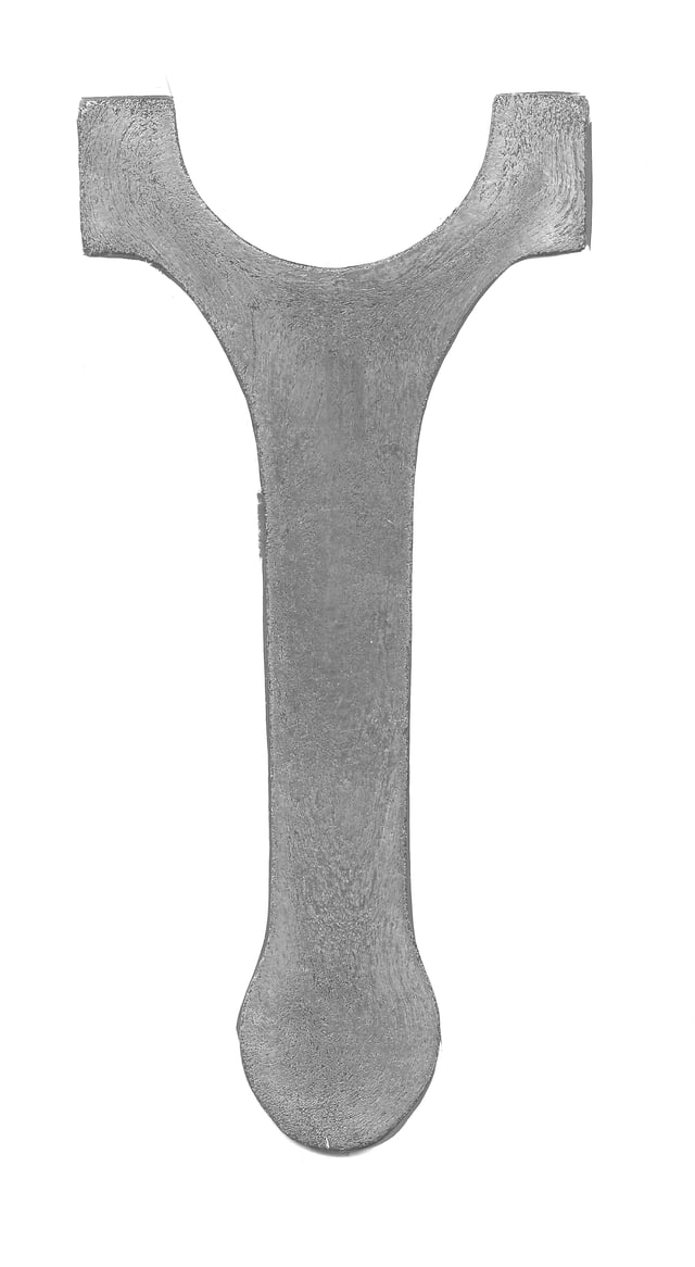 A cross-section of a forged connecting rod that has been etched to show the grain flow