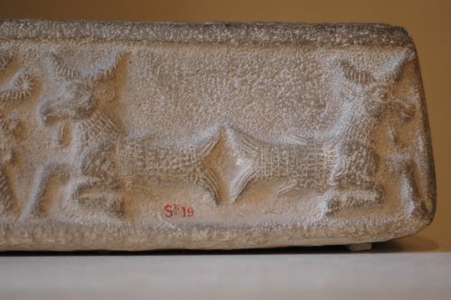 An ornate design on this limestone ritual vat from the Middle Elamite period depicts creatures with the heads of goats and the tails of fish (1500–1110 BC).