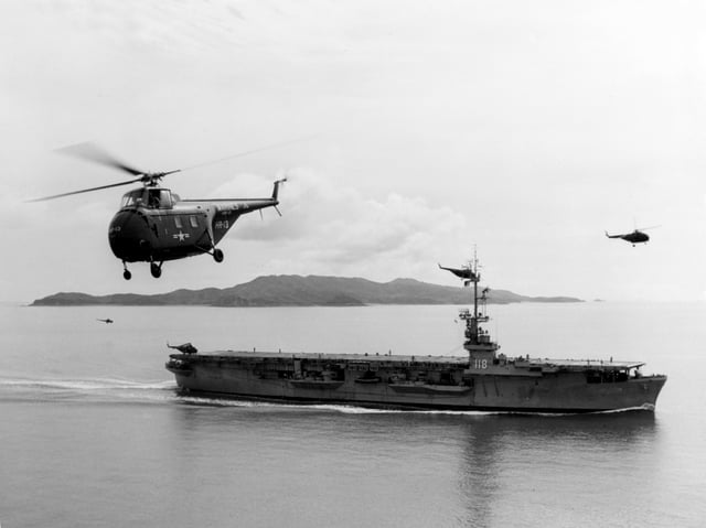 A US Navy Sikorsky HO4S flying near USS Sicily