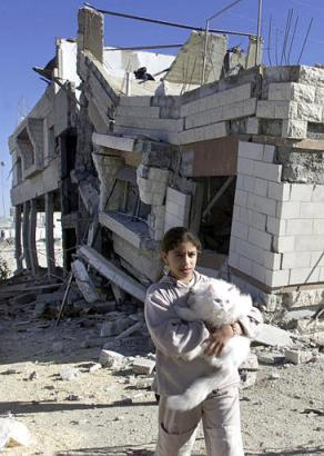 Palestinian girl in front of a demolished home in Balata refugee camp, 2002