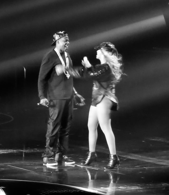 Jay-Z embraces wife Beyoncé after his performance of "Tom Ford" on The Mrs. Carter Show World Tour, 2013