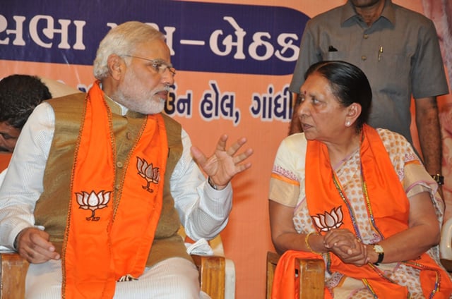 Modi with Anandiben Patel at a meeting of BJP MLAs after his election as prime minister; Patel succeeded him as Gujarat chief minister.