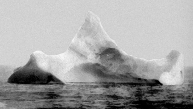 The iceberg thought to have been hit by Titanic, photographed the morning of 15 April 1912 by SS Prinz Adalbert's chief steward.  The iceberg was reported to have a streak of red paint from a ship's hull along its waterline on one side.