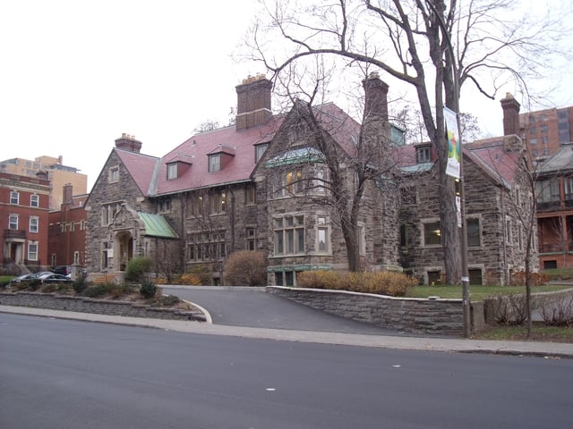 This former mansion in the Tudor revival style was completed in 1926 and retains most of its original interiors, including ornate dark wood panelling with a decorative frieze.