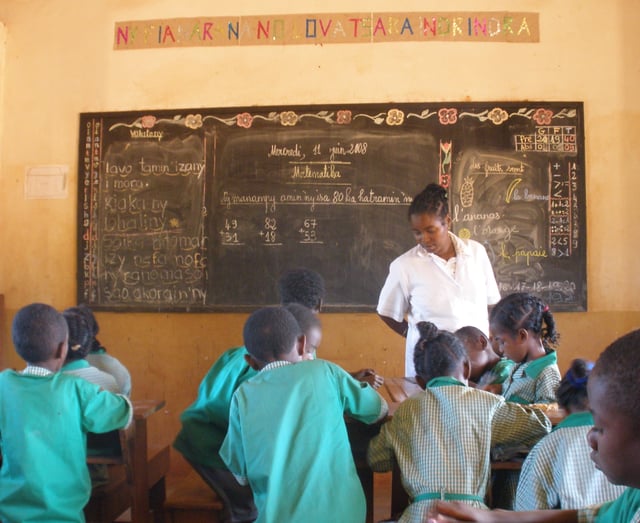 Teacher in a classroom in Madagascar (c. 2008). Teaching is often considered a feminine occupation.