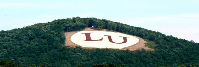 The initials of Liberty University, on Candler Mountain, as viewed from near campus