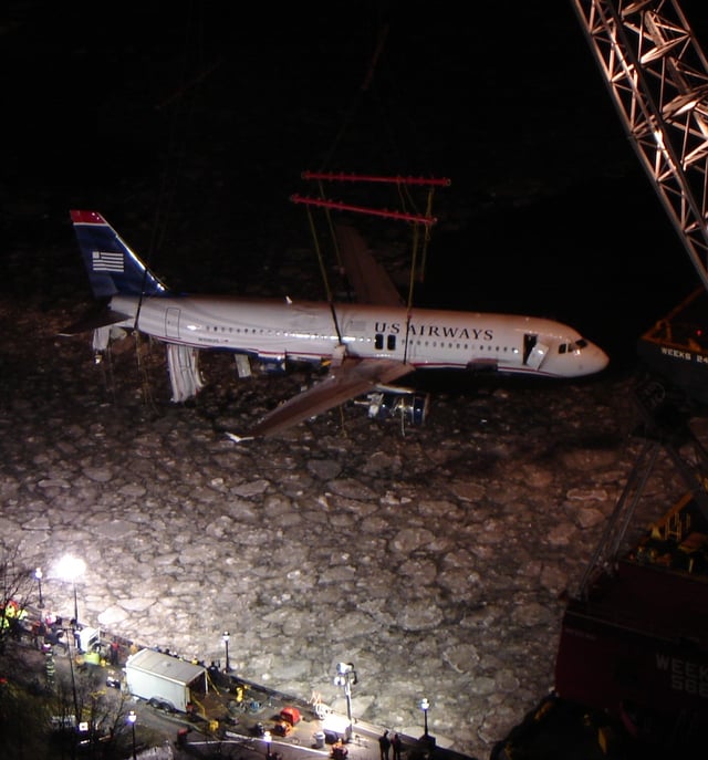 The plane being recovered from the river during the night of January 17