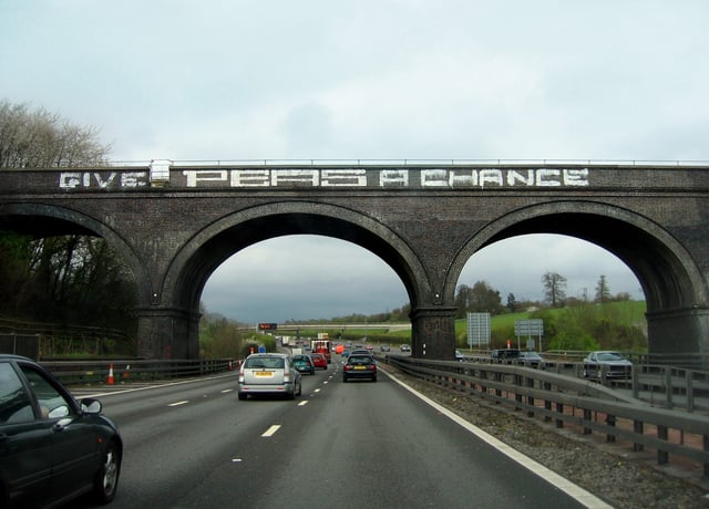 The "Give Peas A Chance" graffiti on the Chalfont Viaduct, before its removal in 2018