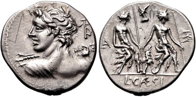 Denarius of Lucius Caesius, 112–111 BC. On the obverse is Apollo, as written on the monogram behind his head, who also wears the attributes of Vejovis, an obscure deity. The obverse depicts a group of statues representing the Lares Praestites, which was described by Ovid.